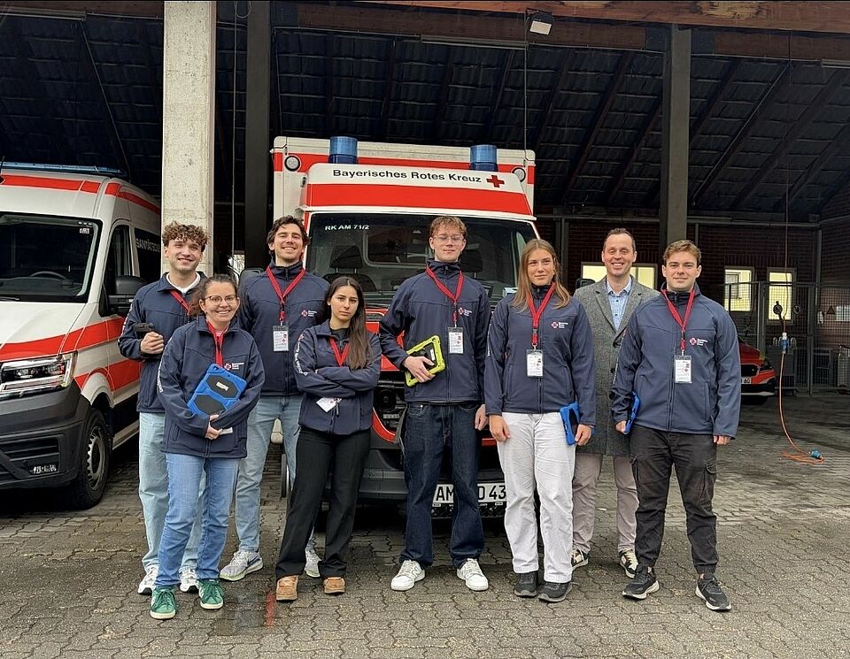 Studierende stehen vor einem Rettungswagen des Bayerischen Roten Kreuzes